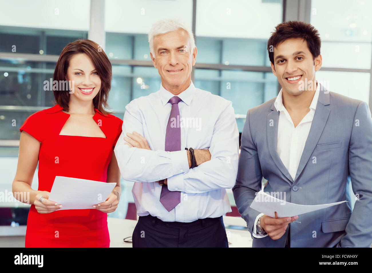 Group of businesspeople in office standing Stock Photo - Alamy