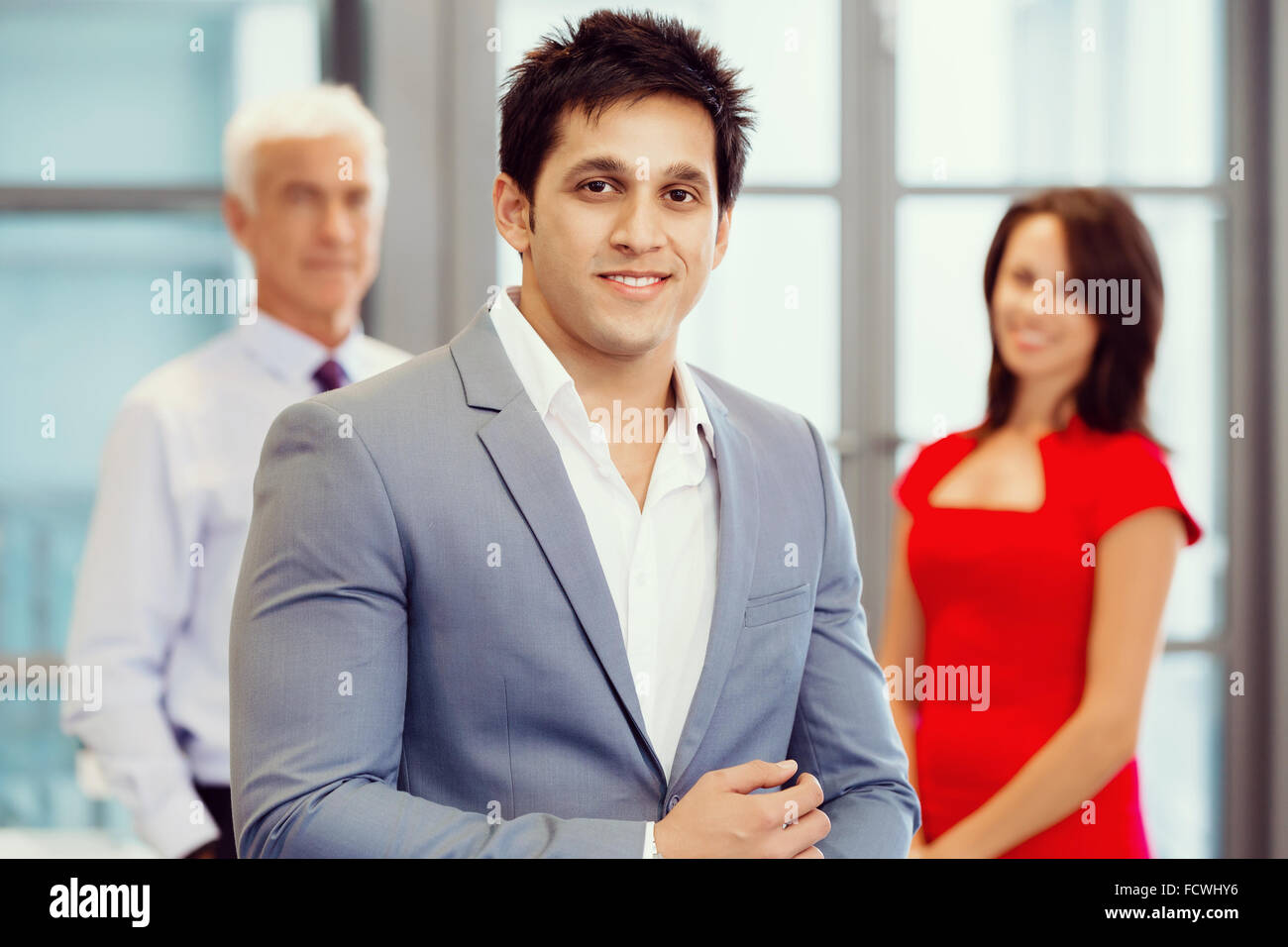 Group of businesspeople in office standing Stock Photo - Alamy