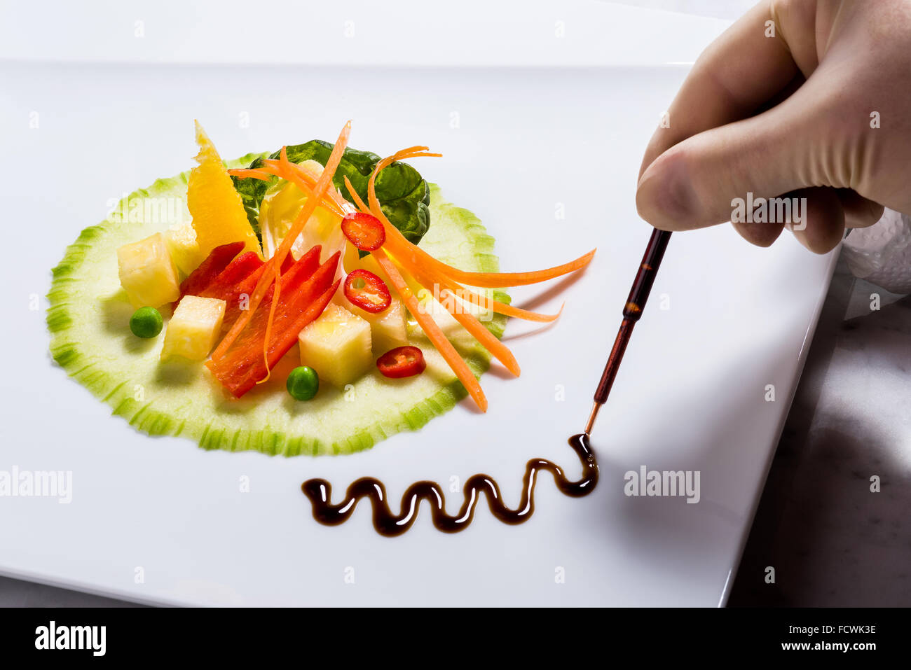 Salad Creation Fitness salad garnish with pipette, balsamico track, plastic, handmade, deco with hand, cook cooking salateria fr Stock Photo