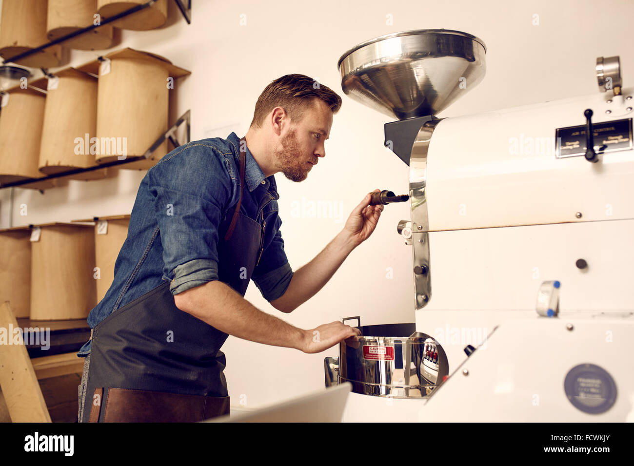 Person operating a coffee roasting machine hires stock photography and images Alamy