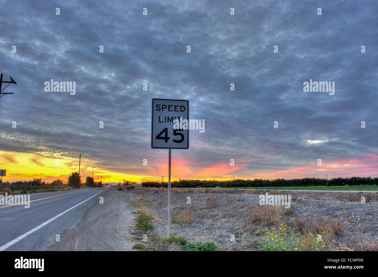 Cirrocumulus clouds over speed limit sign Stock Photo Alamy
