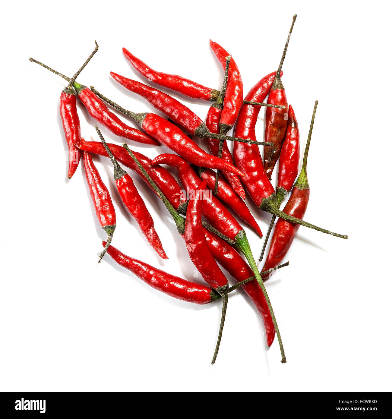 A group of red birds eye chillies on a white background Stock Photo