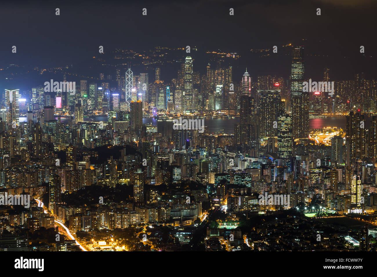 View of Kowloon and Hong Kong Island from above in Hong Kong, China, at night. Stock Photo