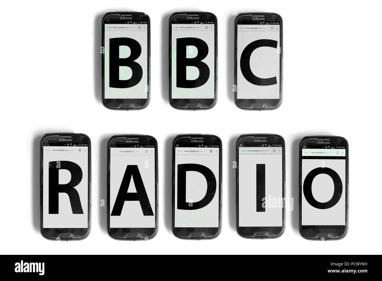 BBC Radio written on the screens of smartphone photographed against a white background. Stock Photo