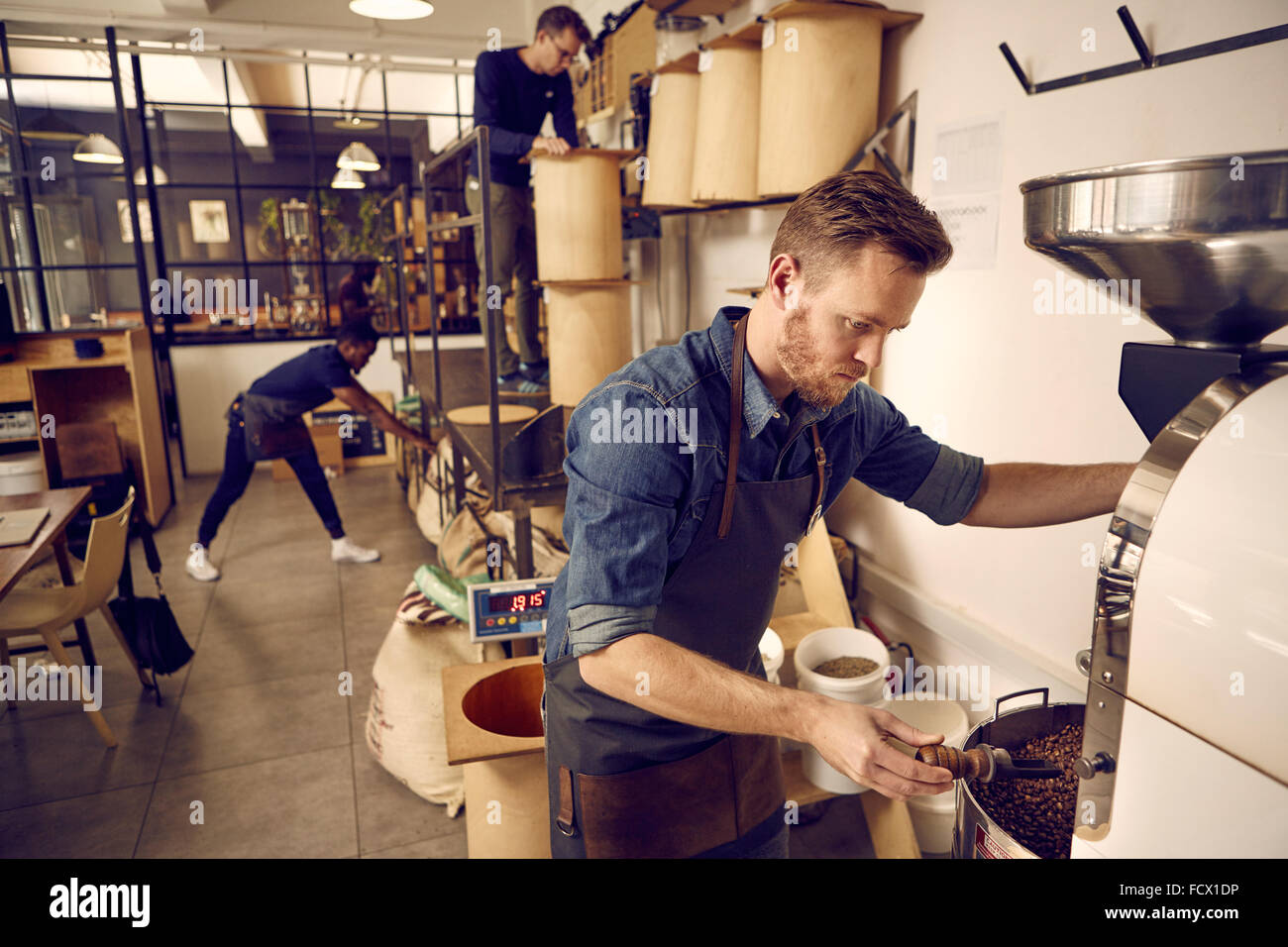 Coffee roastery and distribution company with men at work Stock Photo