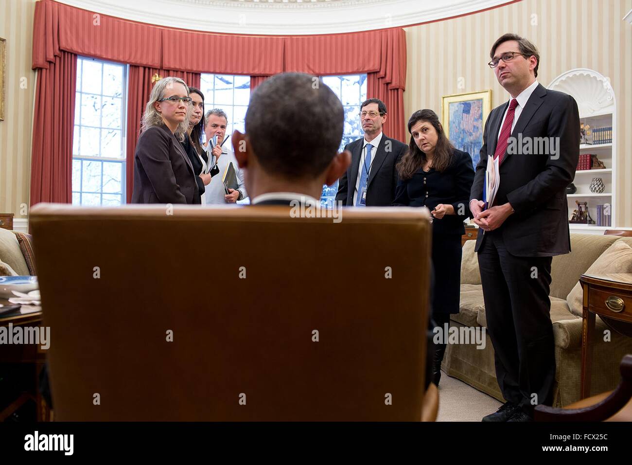 U.S. President Barack Obama talks with participants following a Council of Economic Advisers meeting in the Oval Office of the White House March 5, 2015 in Washington, DC. Standing from left are: Abigail Wozniak, CEA Senior Economist; Jessica Schumer, CEA Chief of Staff and General Counsel; National Economic Council Director Jeffrey Zients; CEA Member Maurice Obstfeld; CEA Member Betsey Stevenson and CEA Chair Jason Furman. Stock Photo