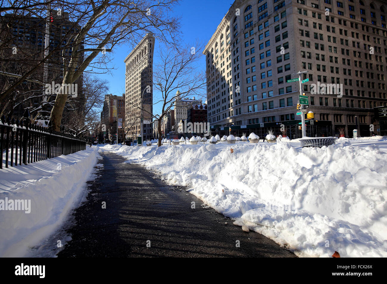 Flatiron Building with snow covered Broadway and Fifth Avenue Stock