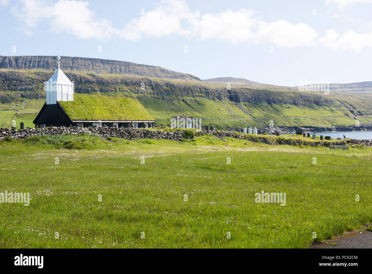 Church in Sandur as seen from outside with landscape and mountain in the background Stock Photo