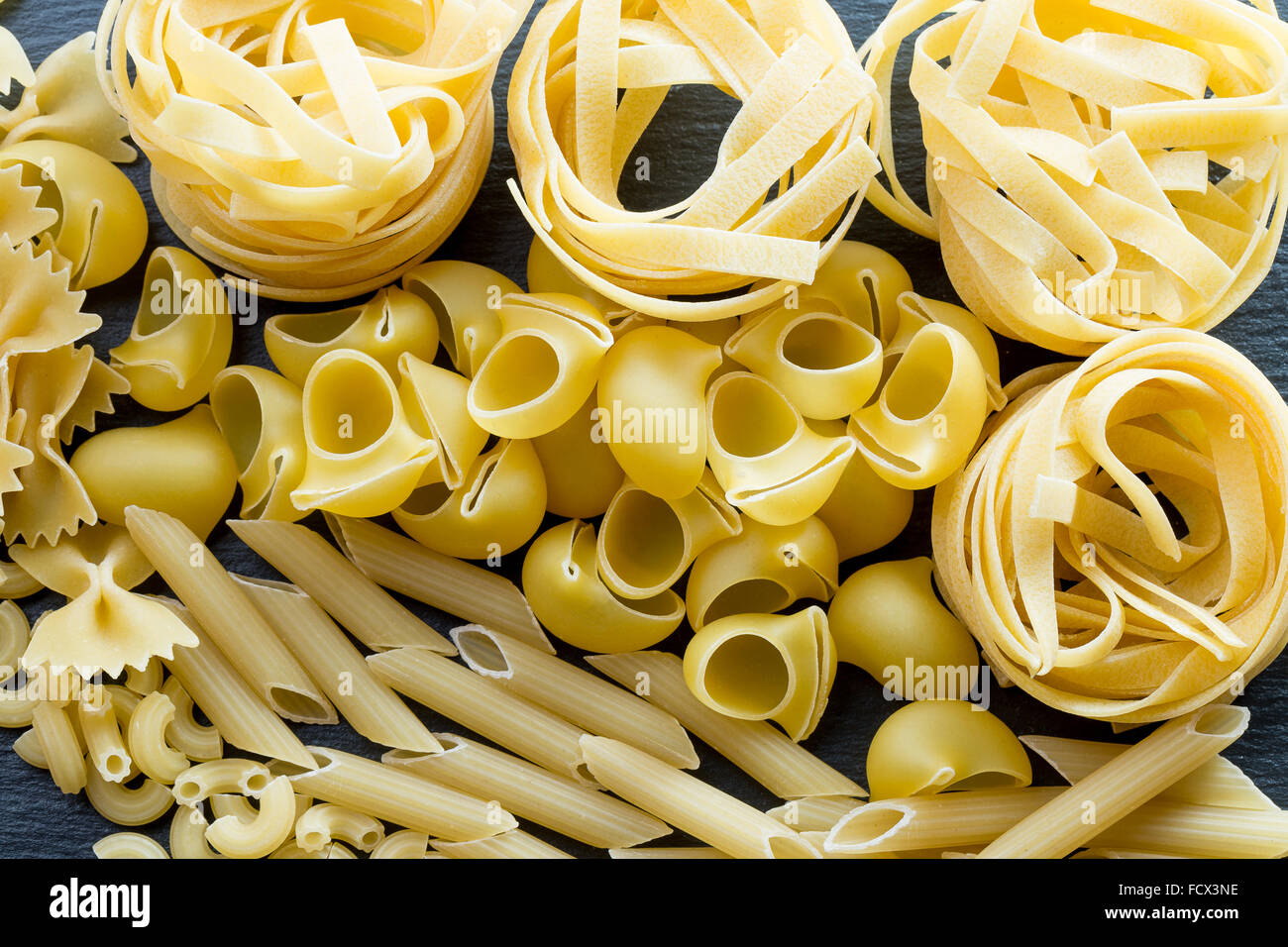 Variety of types and shapes of Italian pasta. Stock Photo