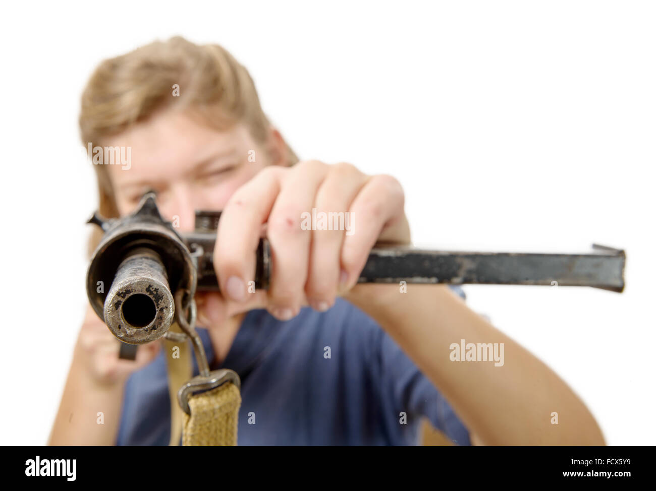 a young woman shooting with a gun isolated on a white background Stock Photo