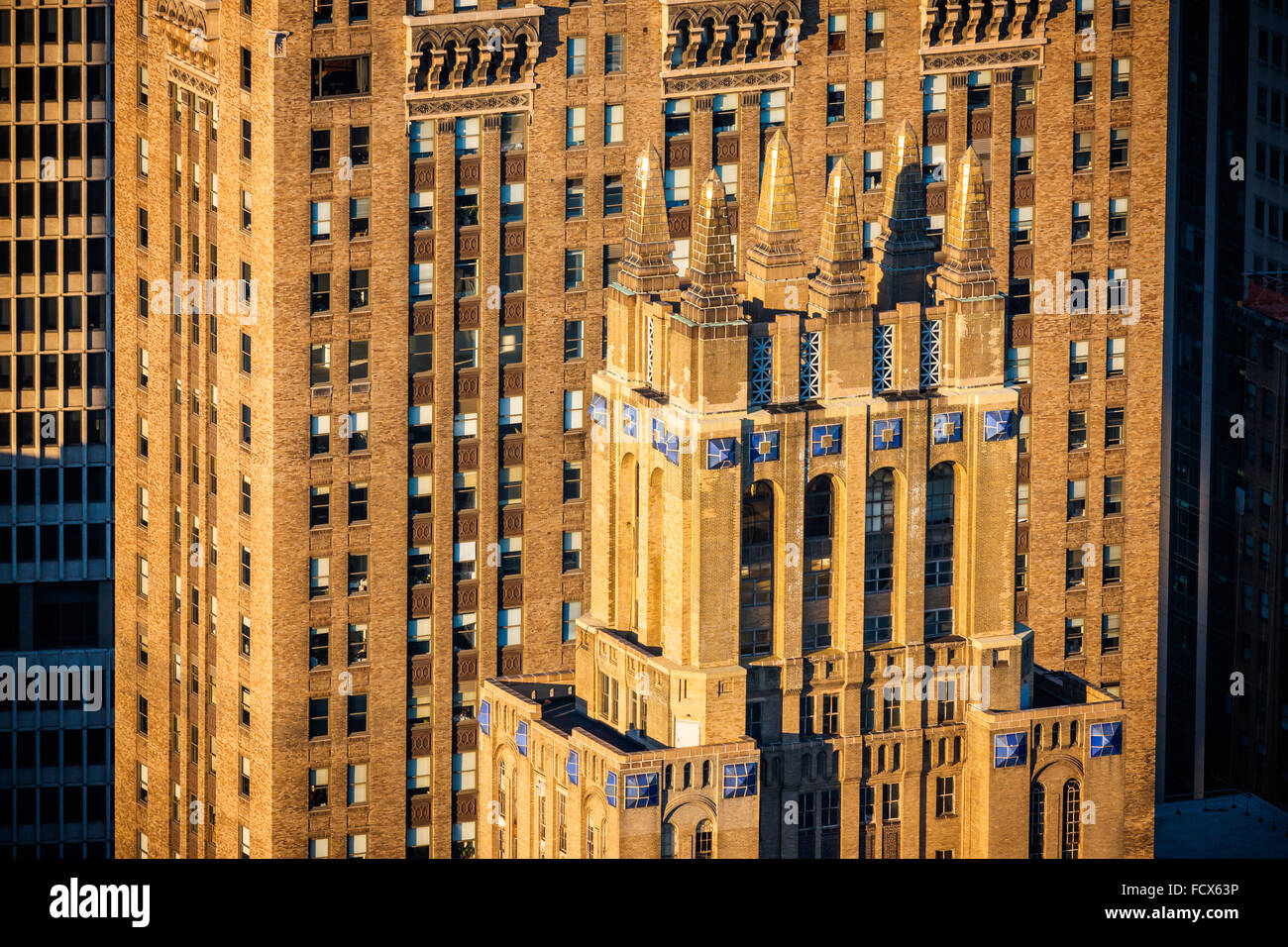 Afternoon light illuminating the facades and architectural details of art deco skyscrapers in Midtown Manhattan. New York City Stock Photo