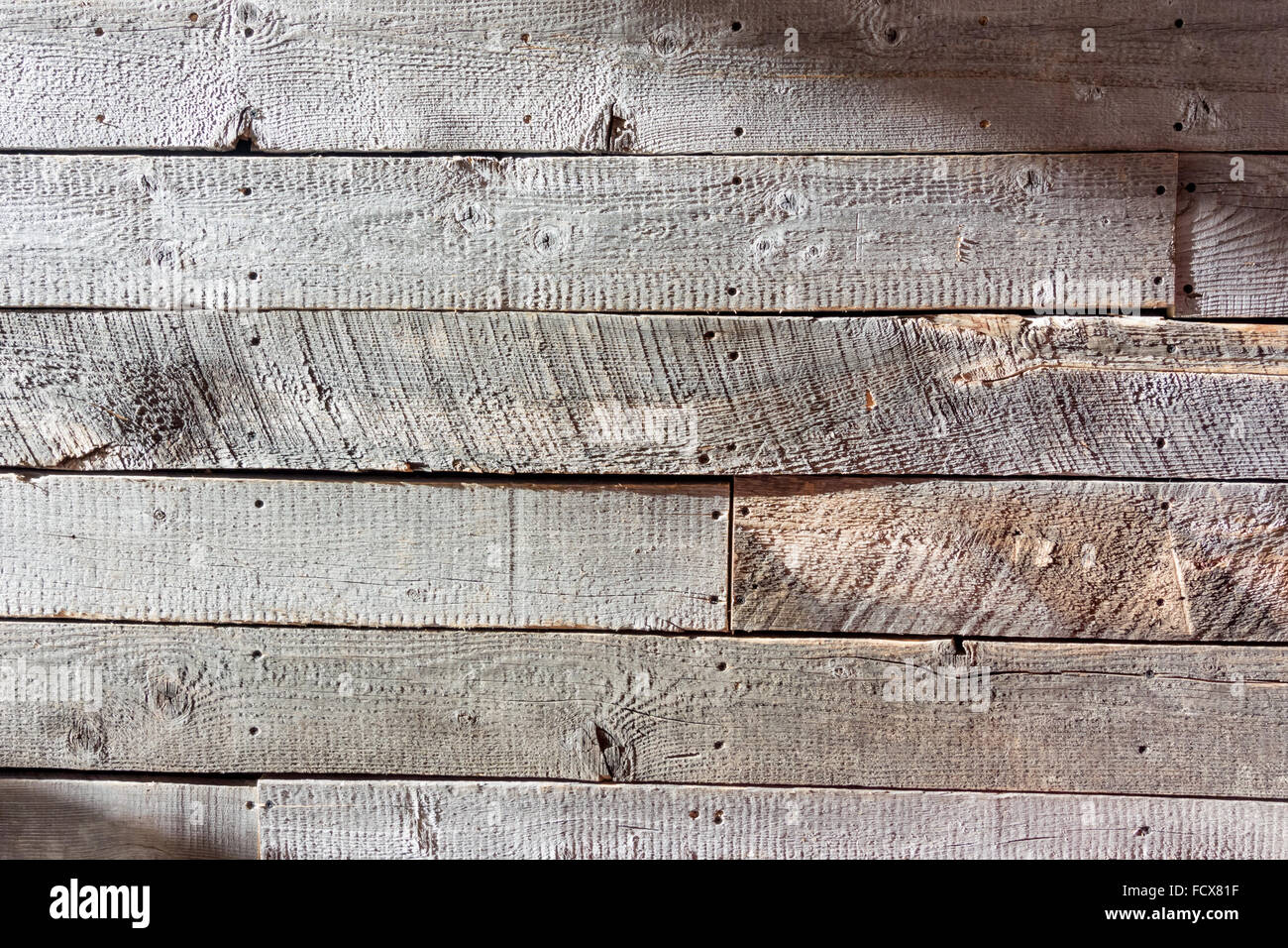 Rough wood wall wide shot captures light and shadow off an unsanded