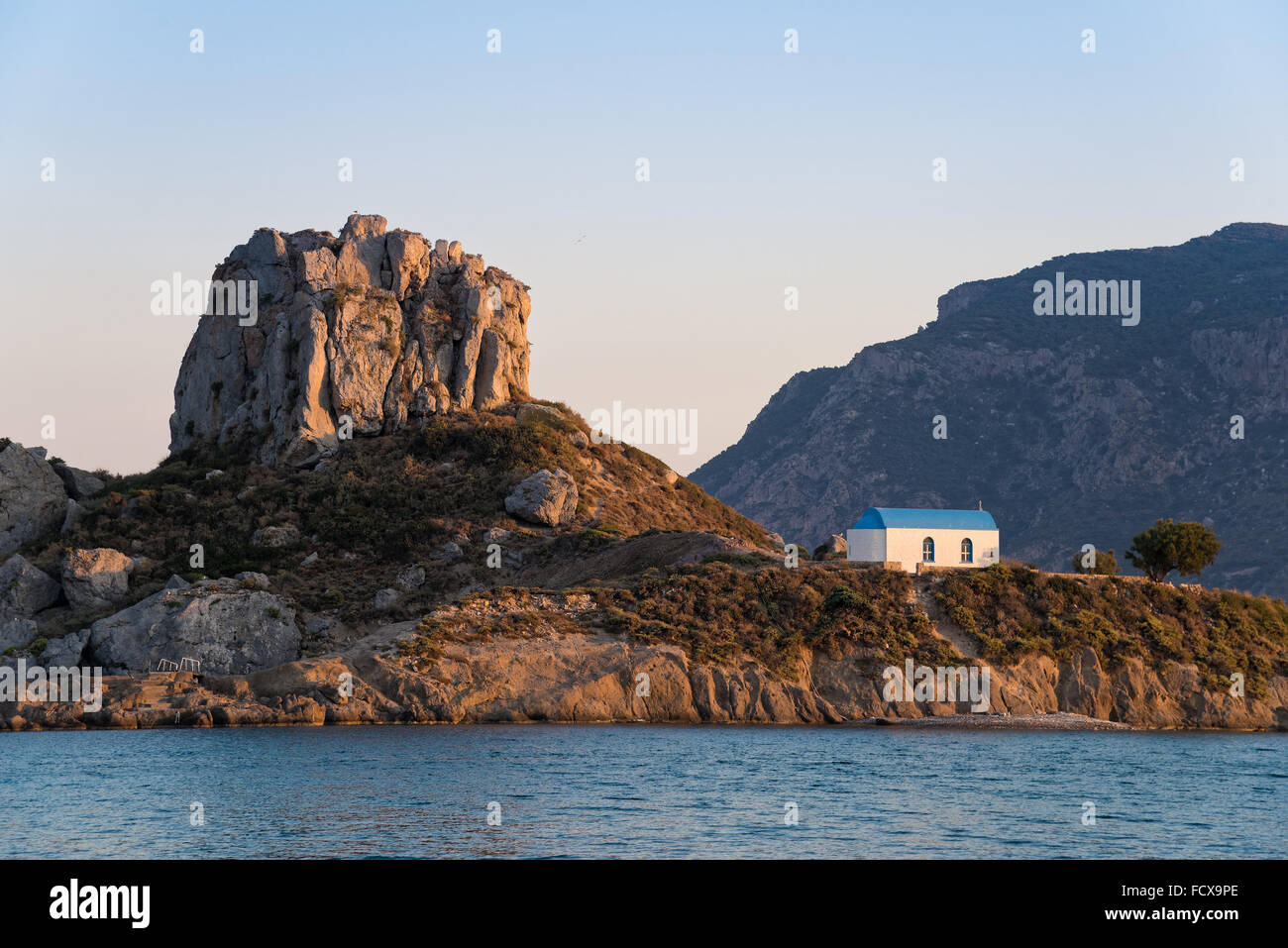Landscape with islet and traditional church at sunset in Kos island, Greece Stock Photo