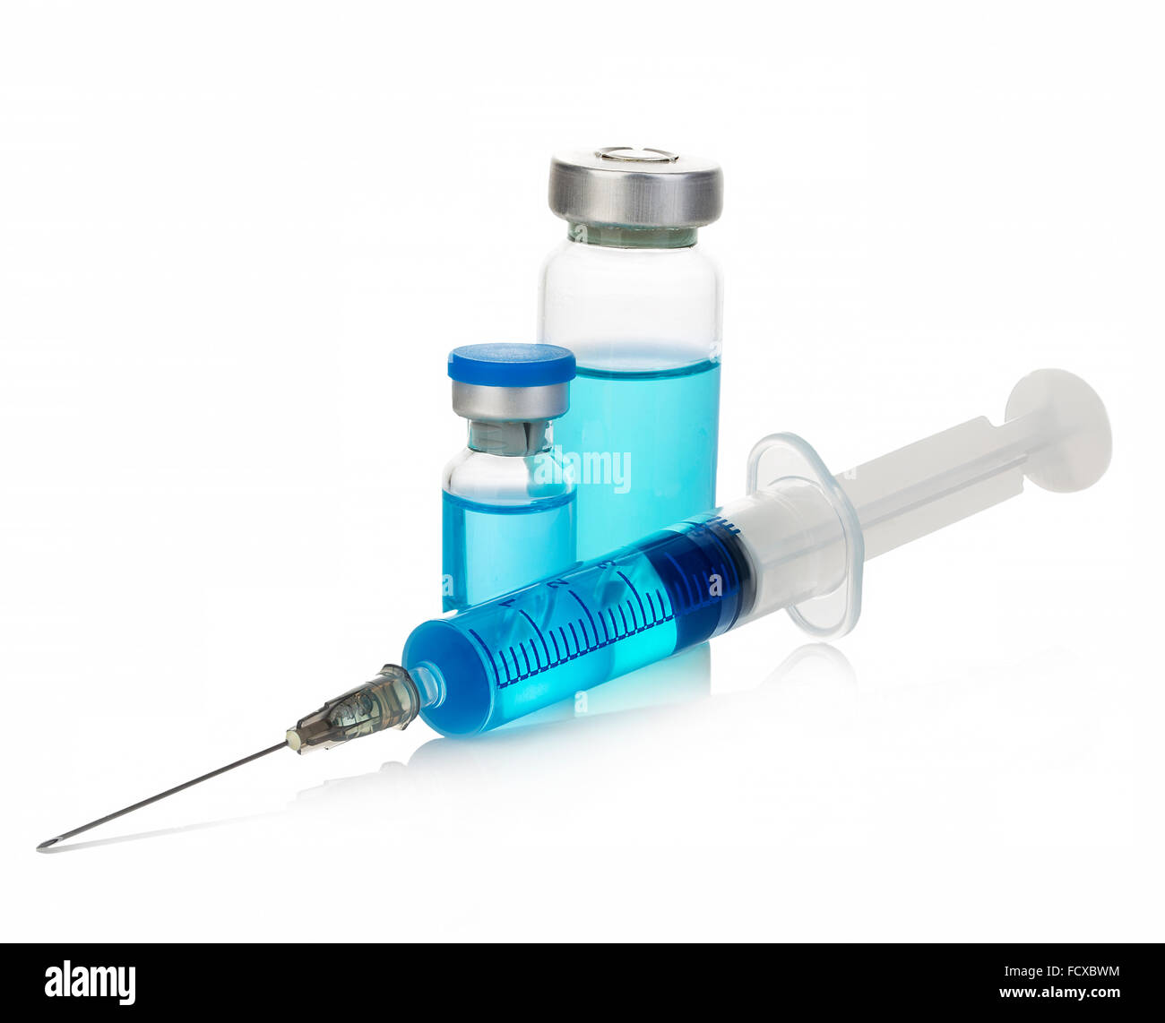 Sterile medical vials with blue medication solution, ampoules, and syringe isolated on a white background. Stock Photo