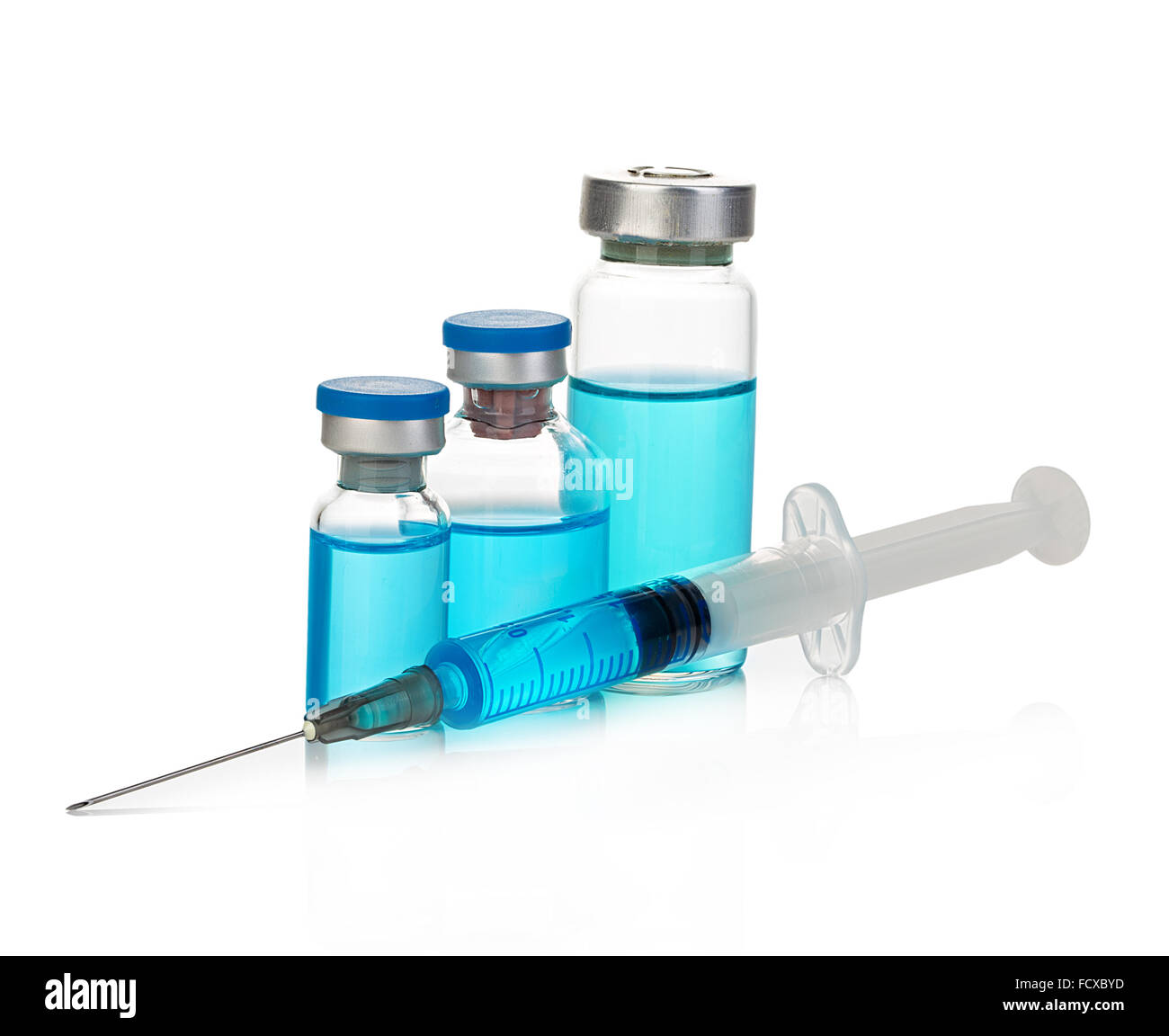 Sterile medical vials with blue medication solution, ampoules, and syringe isolated on a white background. Stock Photo