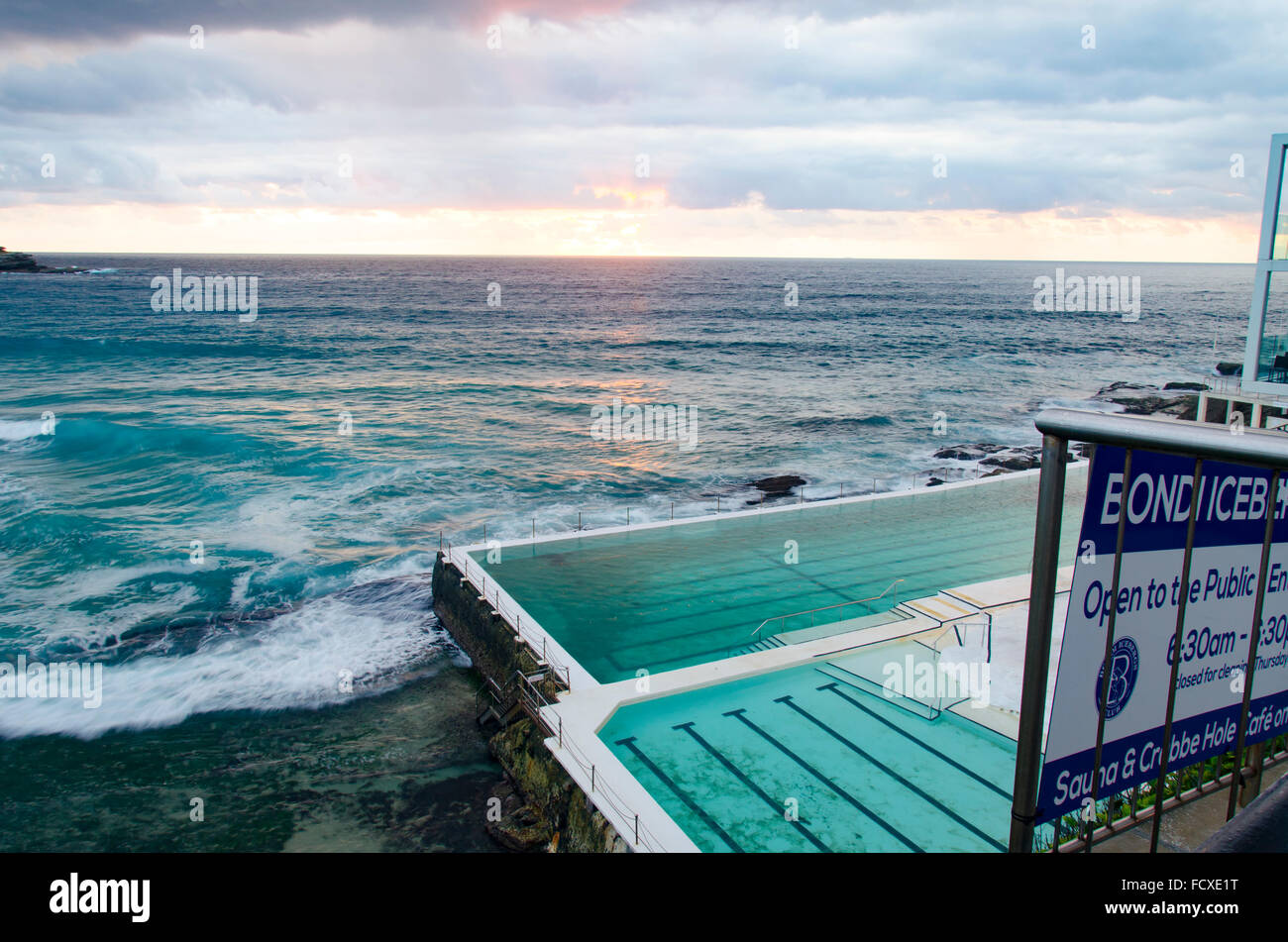 Bondi Beach, Sydney, Australia. 26th Jan, 2016. Sunrise over Sydneys Bondi Beach and Bondi Icebergs pool. Despite being the height of summer, January in Sydney and surrounding regions have experienced record breaking rainfall with more forecast today. Sydney has already received 225 mm of rain in January which is more than double the long term average. Credit:  Sydney Photographer/Alamy Live News Stock Photo