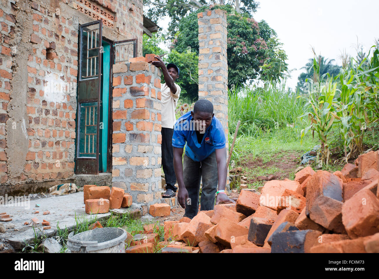 Construction workers work on a mosque in the village of Namayiba