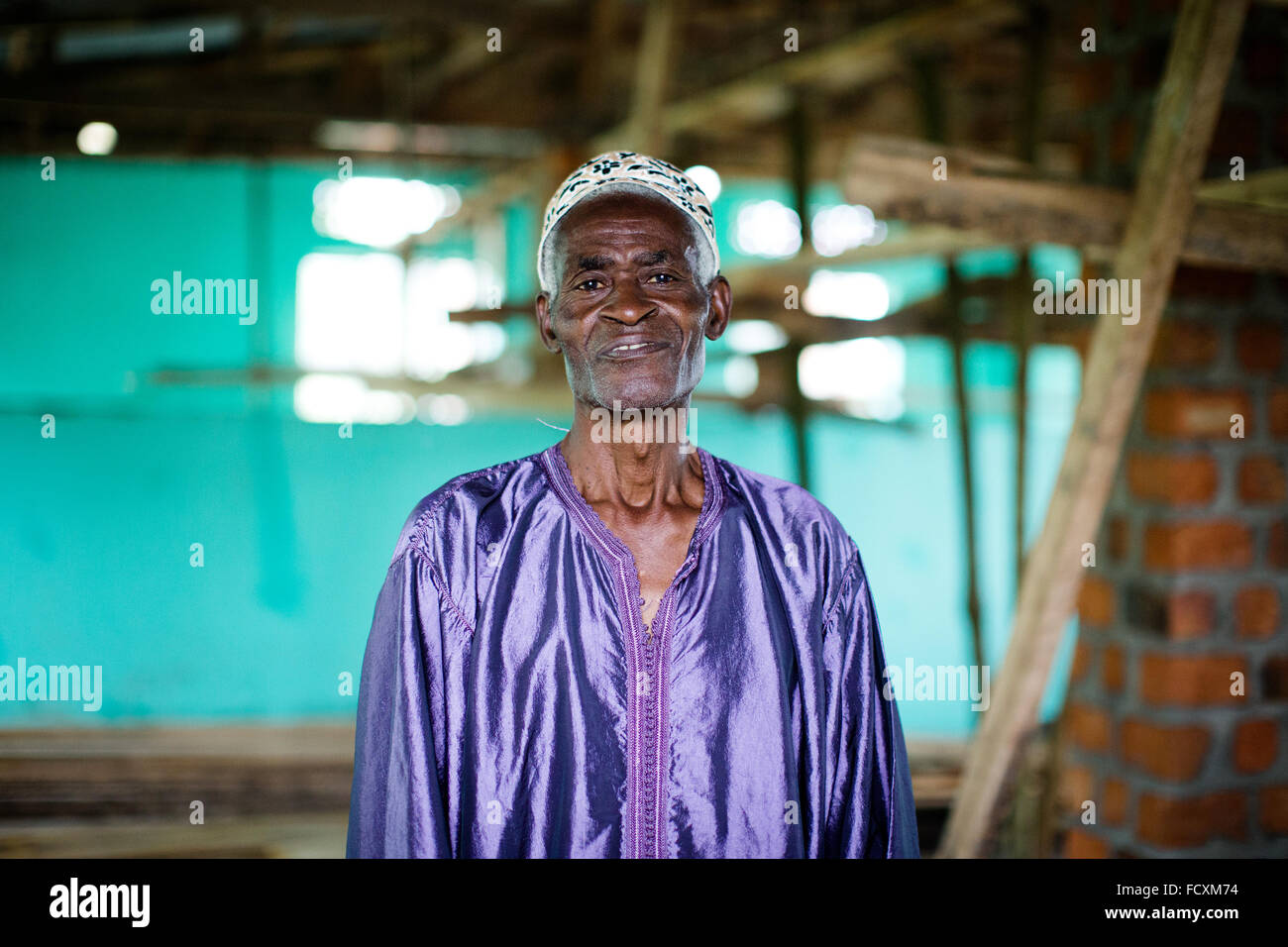 Hadji Twaha Matumbwe, one of the caretakers, poses in the unfinished