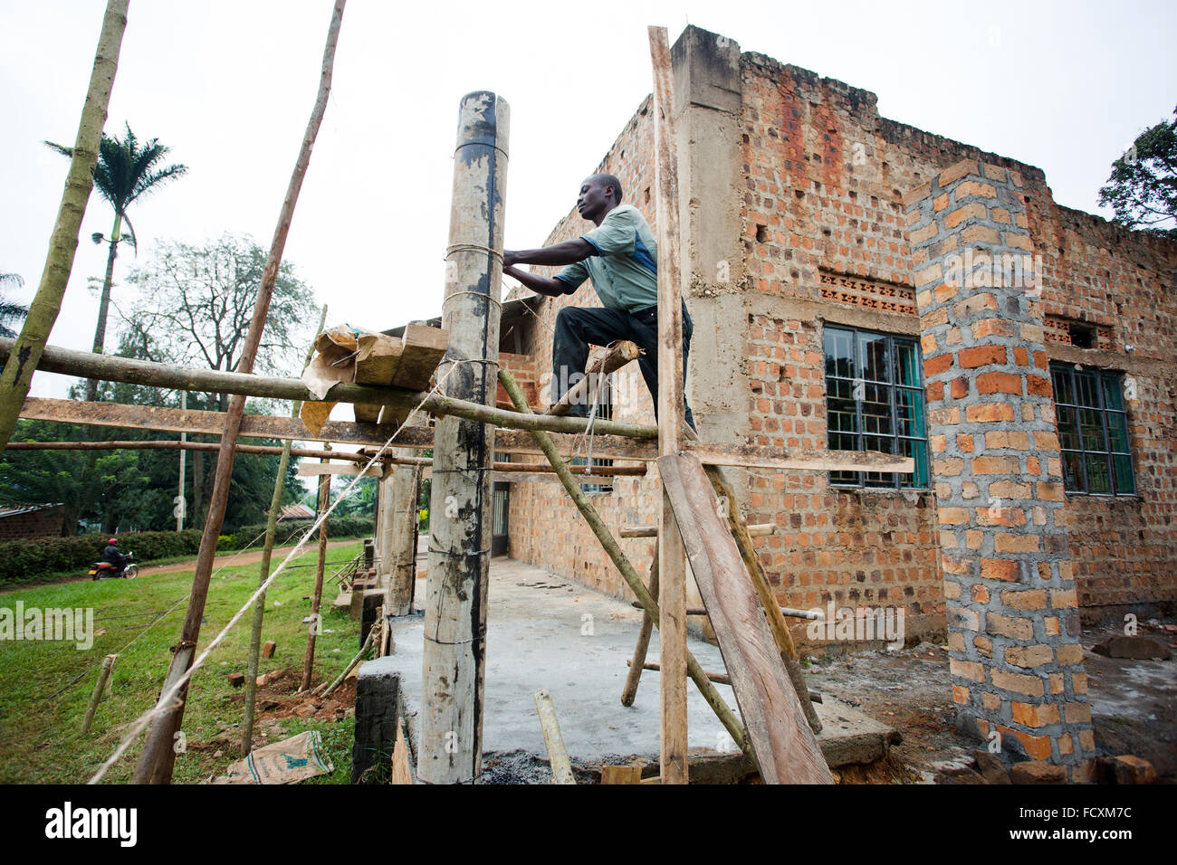 Construction workers work on a mosque in the village of Namayiba