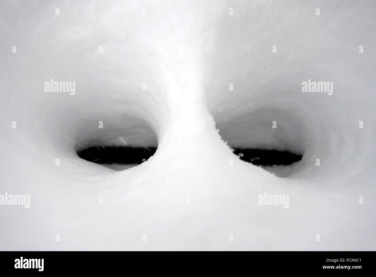 Eyes shaped by melting snow Stock Photo