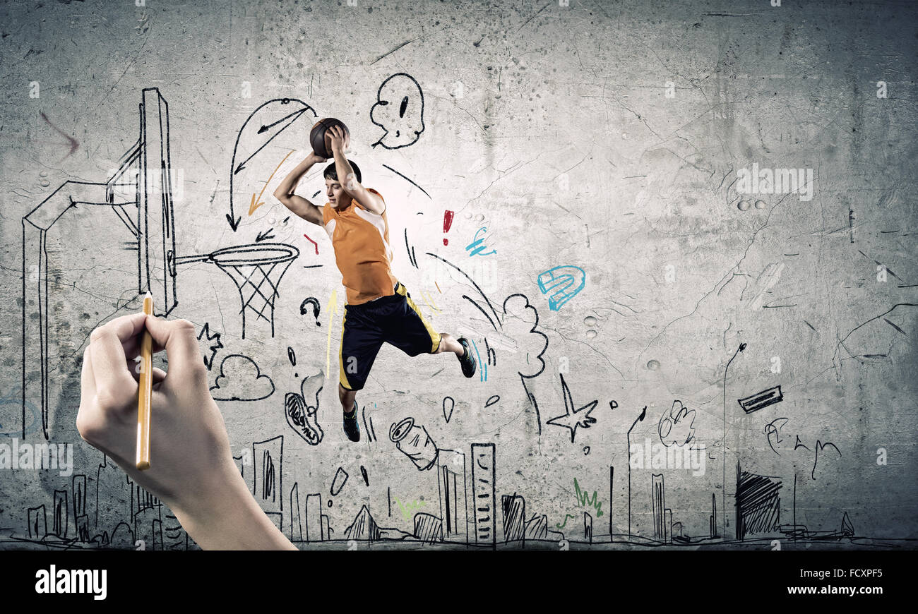 Young man throwing ball into basket in jump Stock Photo - Alamy