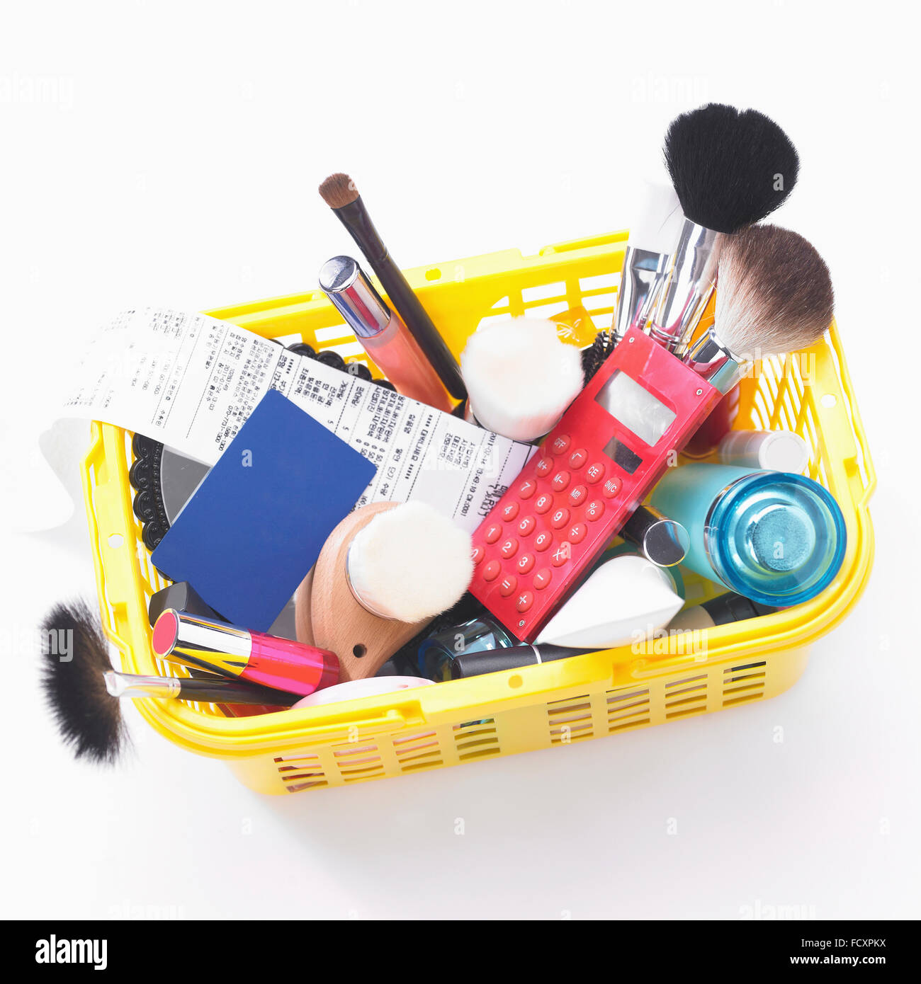 Lots of various objects and receipt in a shopping basket Stock Photo