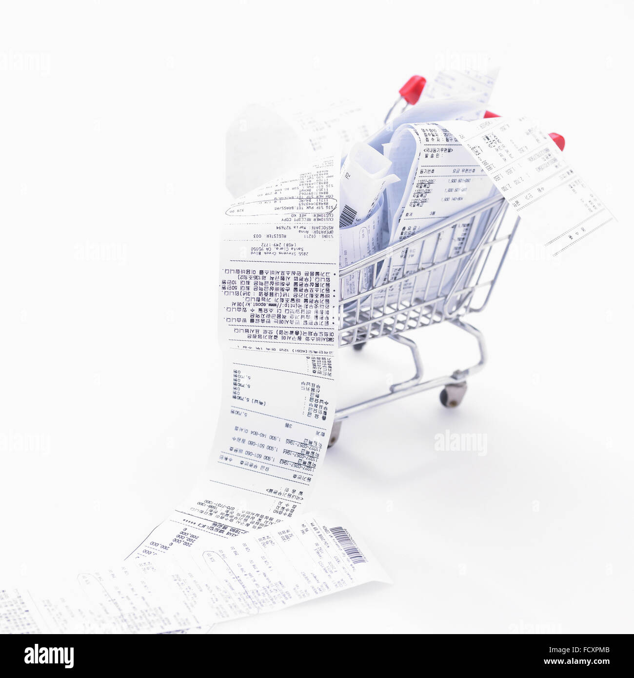 Overflowing receipts in a shopping cart Stock Photo