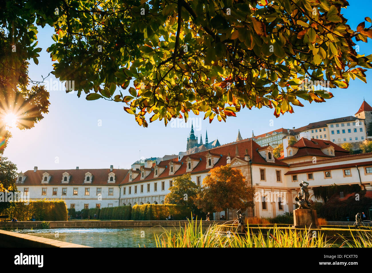 The facade of the palace and portion of the Wallenstein Garden with Prague Castle in the background. Czech Republic Stock Photo