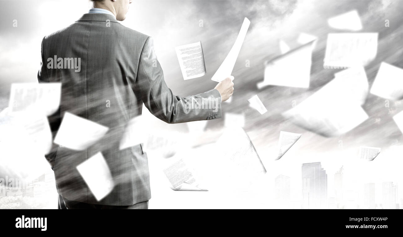 Back view of businessman reading documents in hand Stock Photo Alamy