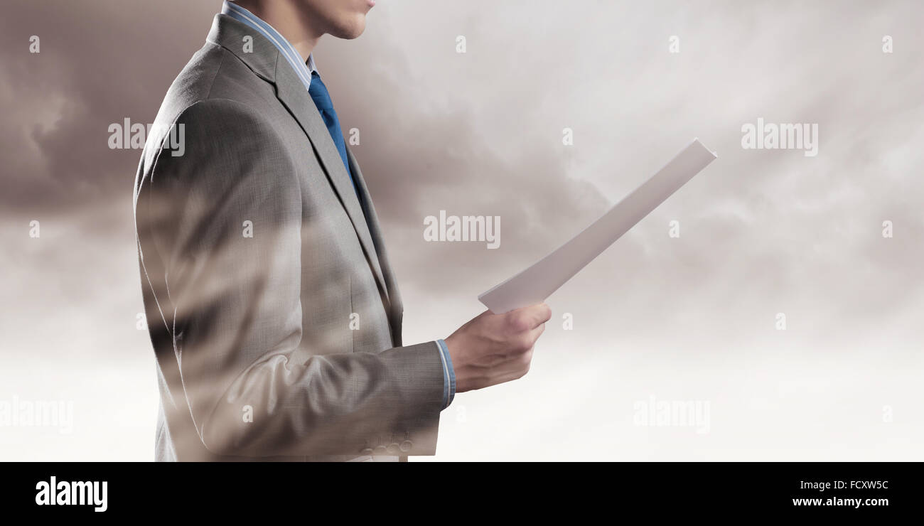 Back view of businessman reading documents in hand Stock Photo Alamy