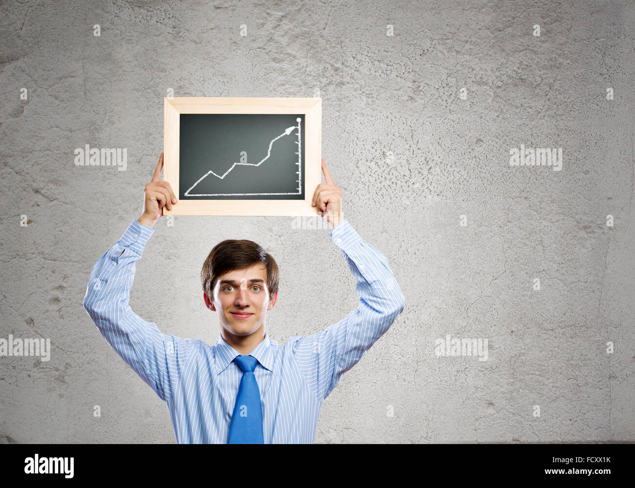 Handsome businessman holding frame with graph drawing Stock Photo - Alamy