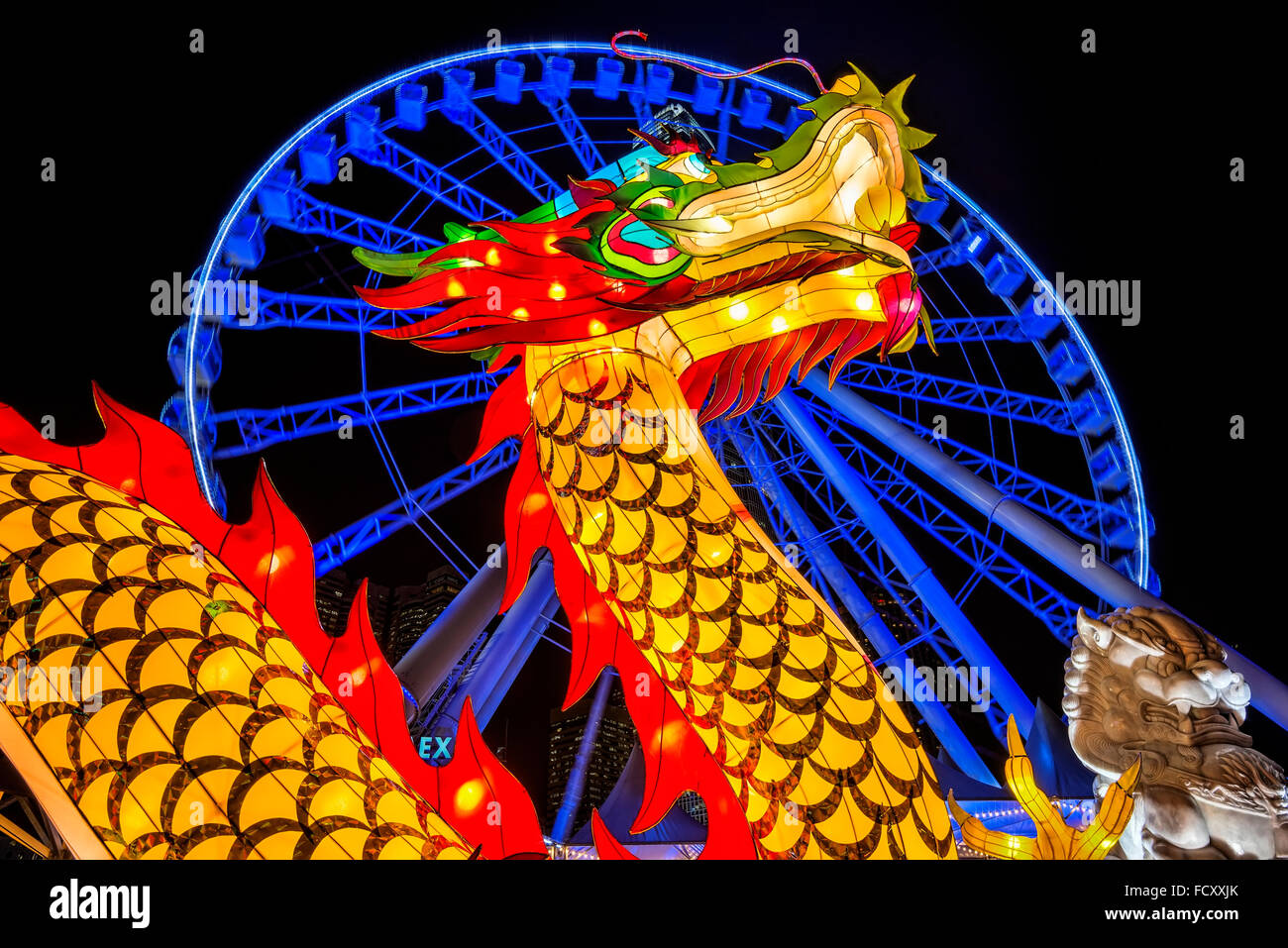 Chinese new year dragon 2016, and the observation wheel, Victoria harbor, Hong Kong, China. Stock Photo