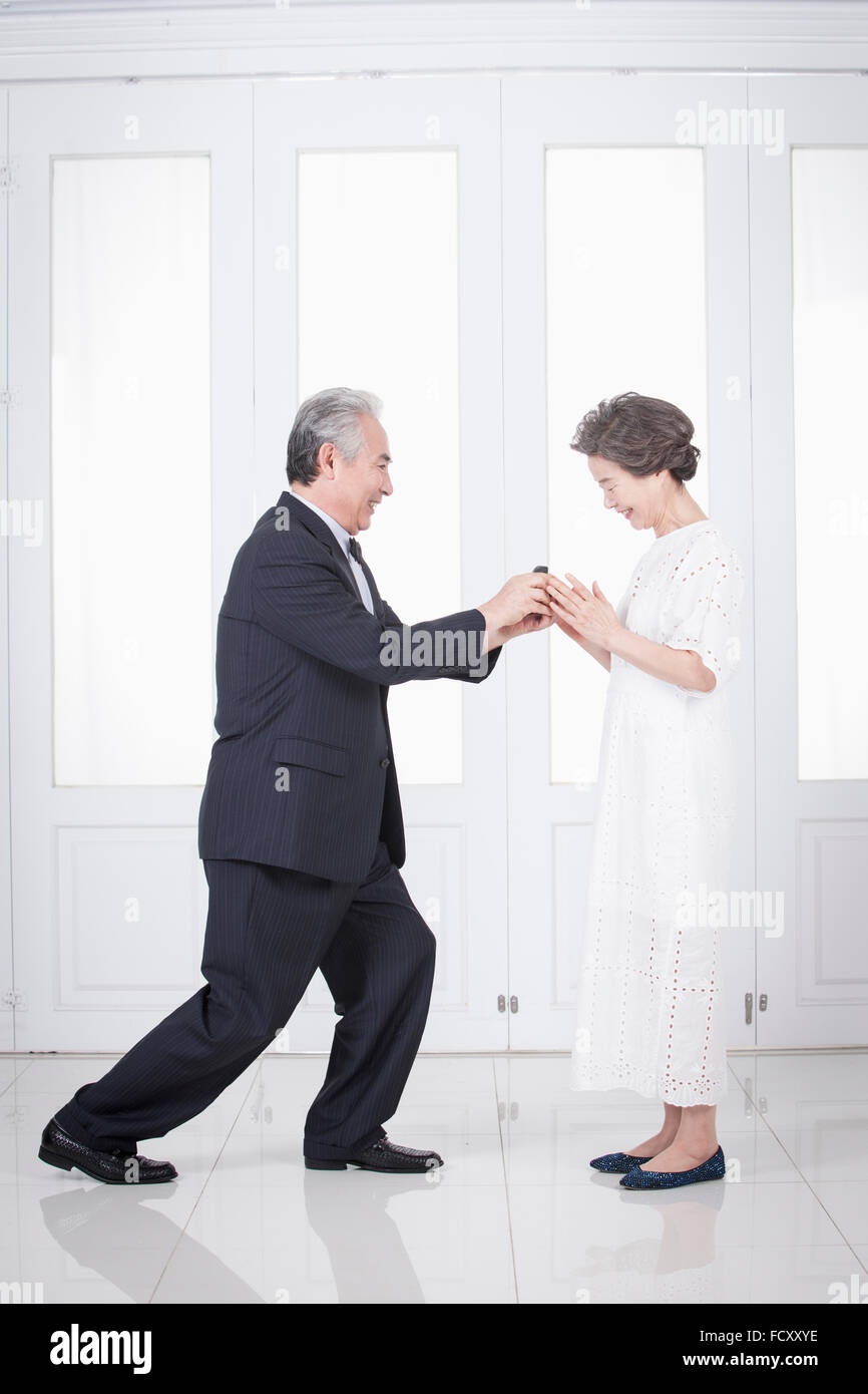 Old man confessing his love to an old woman Stock Photo