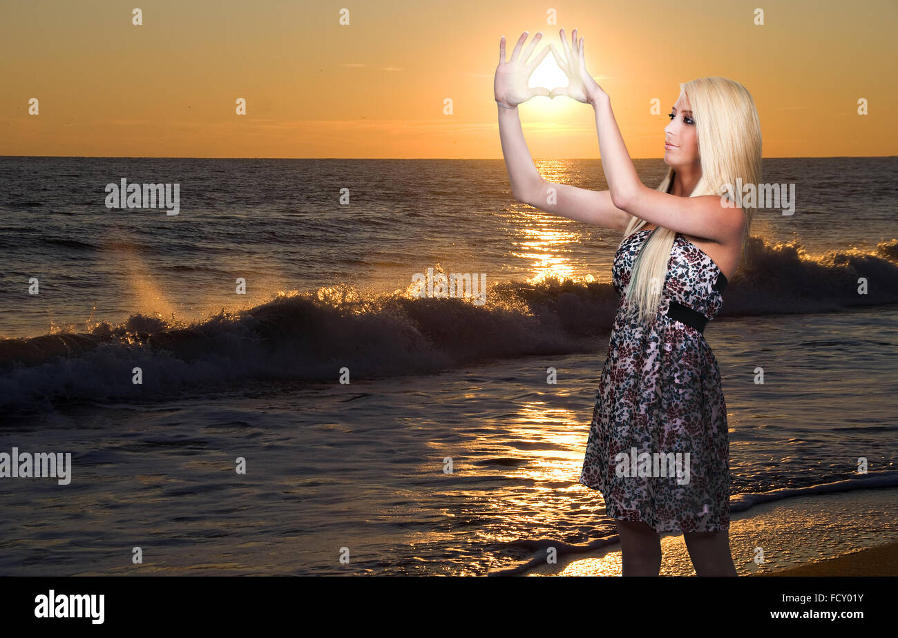 Waves breaking on the beach of an Ocean Sunset Stock Photo - Alamy