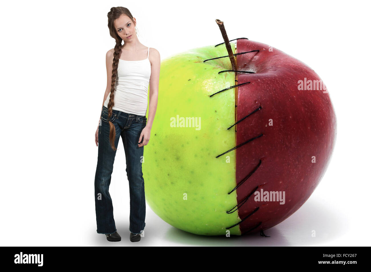 Beautiful teenage woman standing beside a whole red delicious apple with a nutrition label Stock Photo