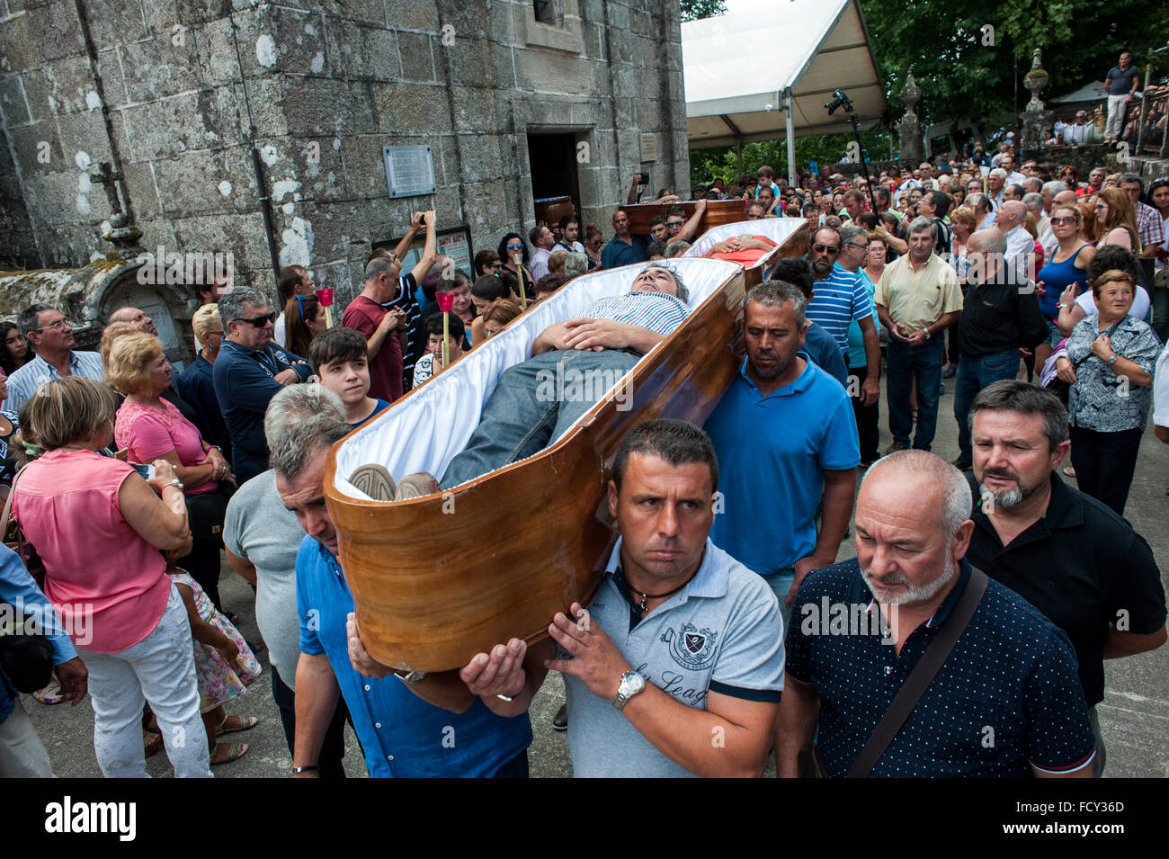 The faithful who consider themselves saved from death by the Santa Marta are carried in coffins during the procession Stock Photo