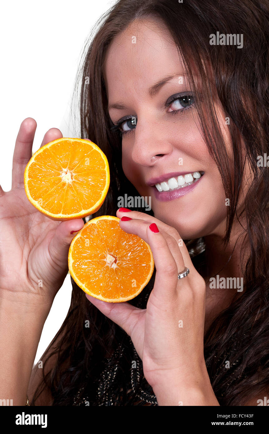 Beautiful woman holding fresh orange slices Stock Photo - Alamy