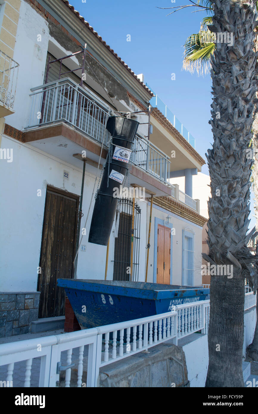 Waste shoot and skip for construction work on a property renovation at Los Alcazares, Murcia, Spain Stock Photo