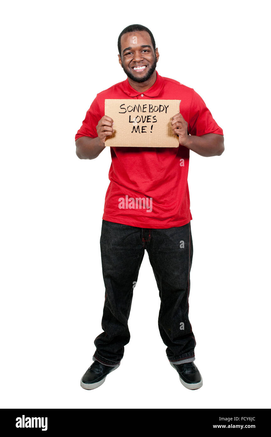 Man holding up a sign that says Somebody Loves Me Stock Photo