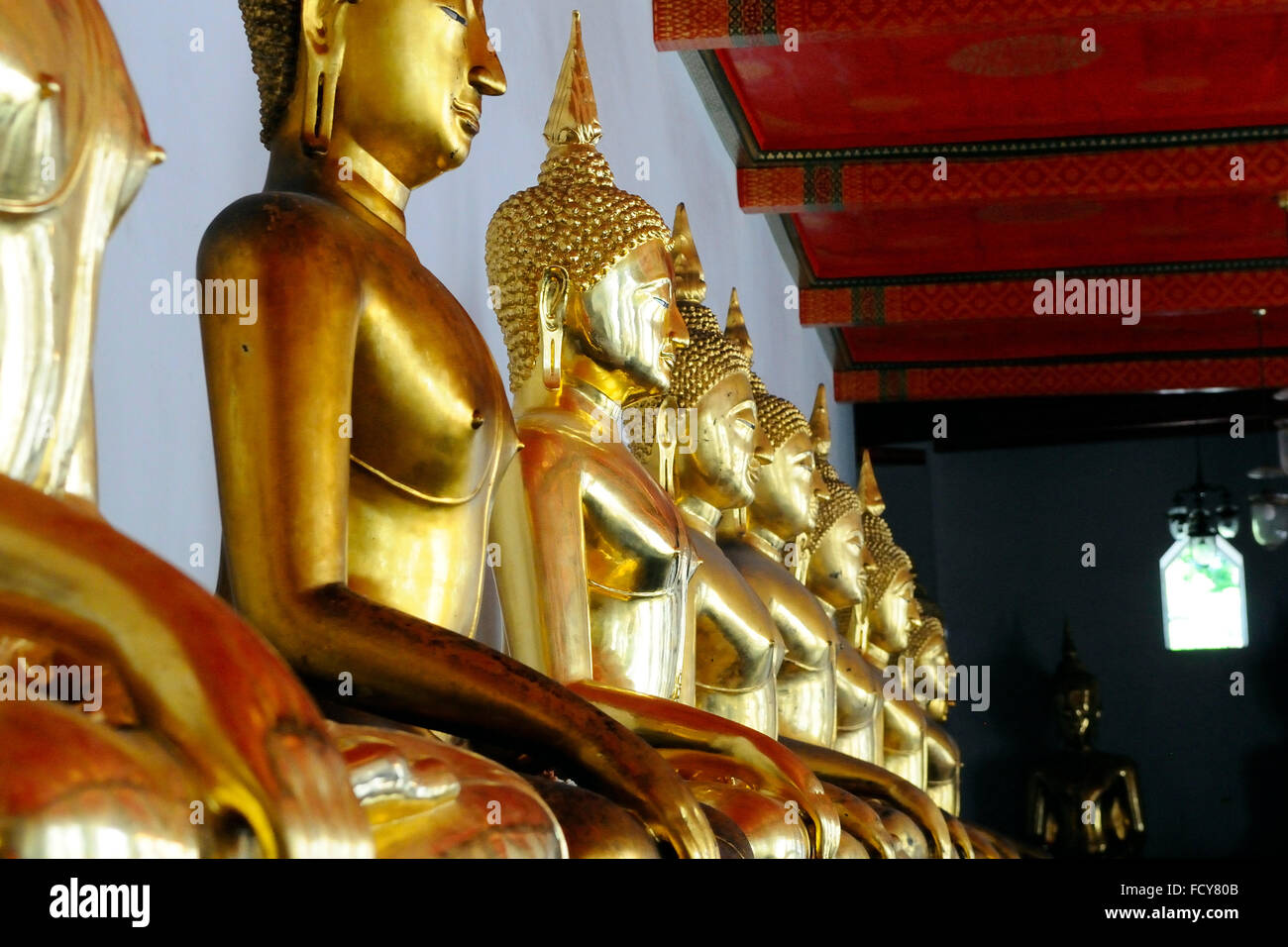 Standing golden Buddha statues. Wat Pho temple, Bangkok, Thailand Stock Photo