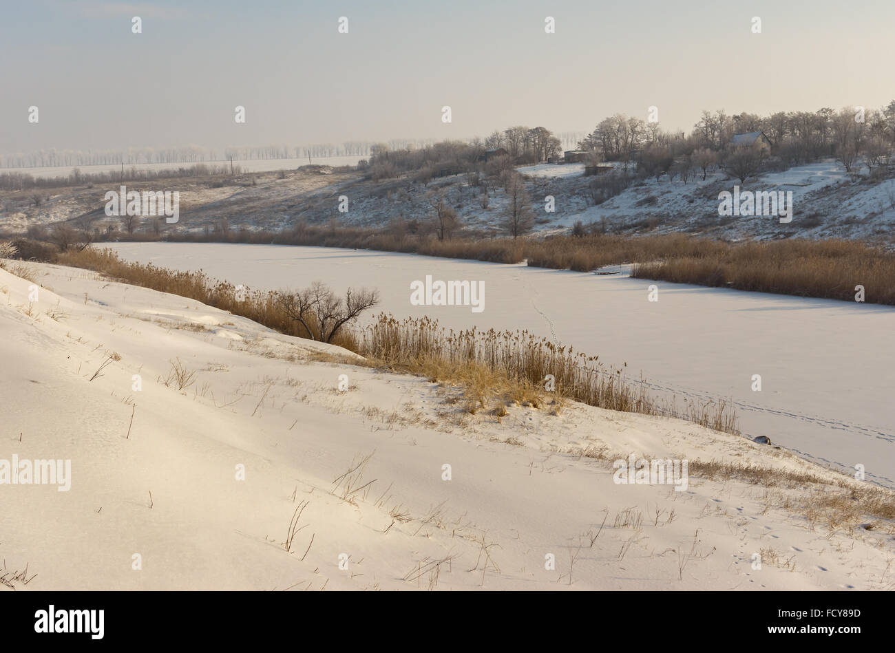 Snowy landscape with Small river Sura flowing through Novo-Nikolaevka village in Dnepropetrovskaya oblast, Ukraine Stock Photo