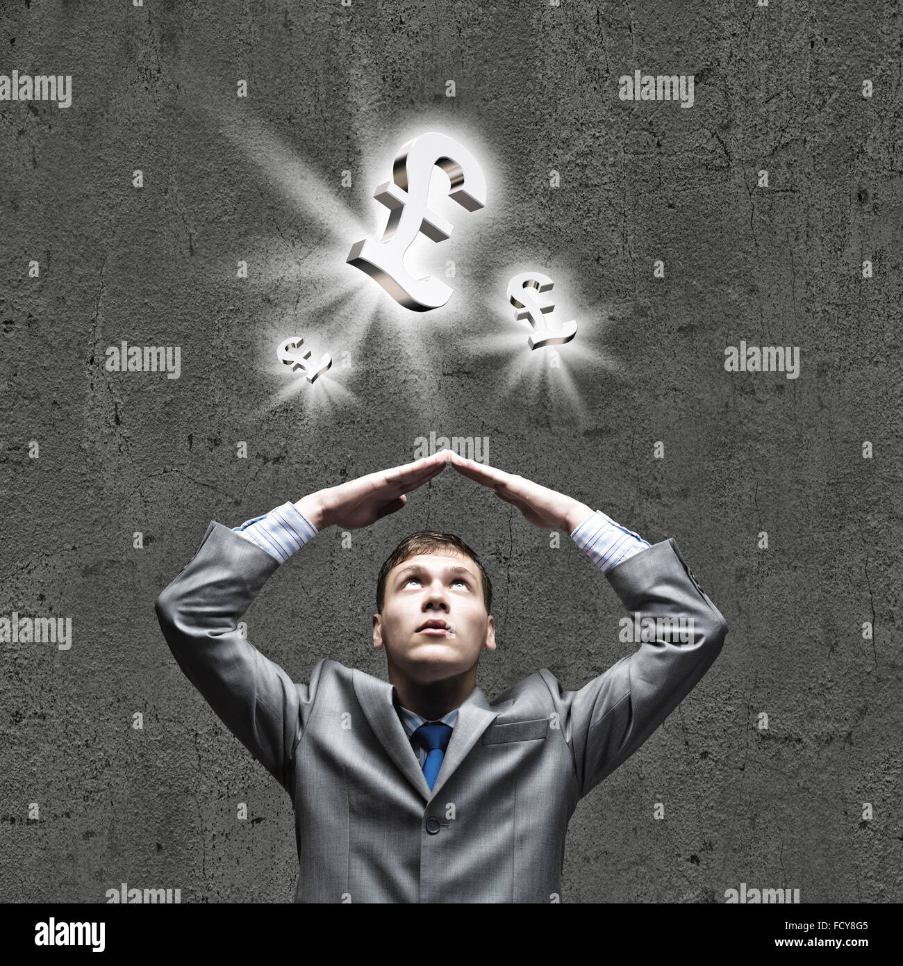 Young businessman Holding arms above head. Money concept Stock Photo