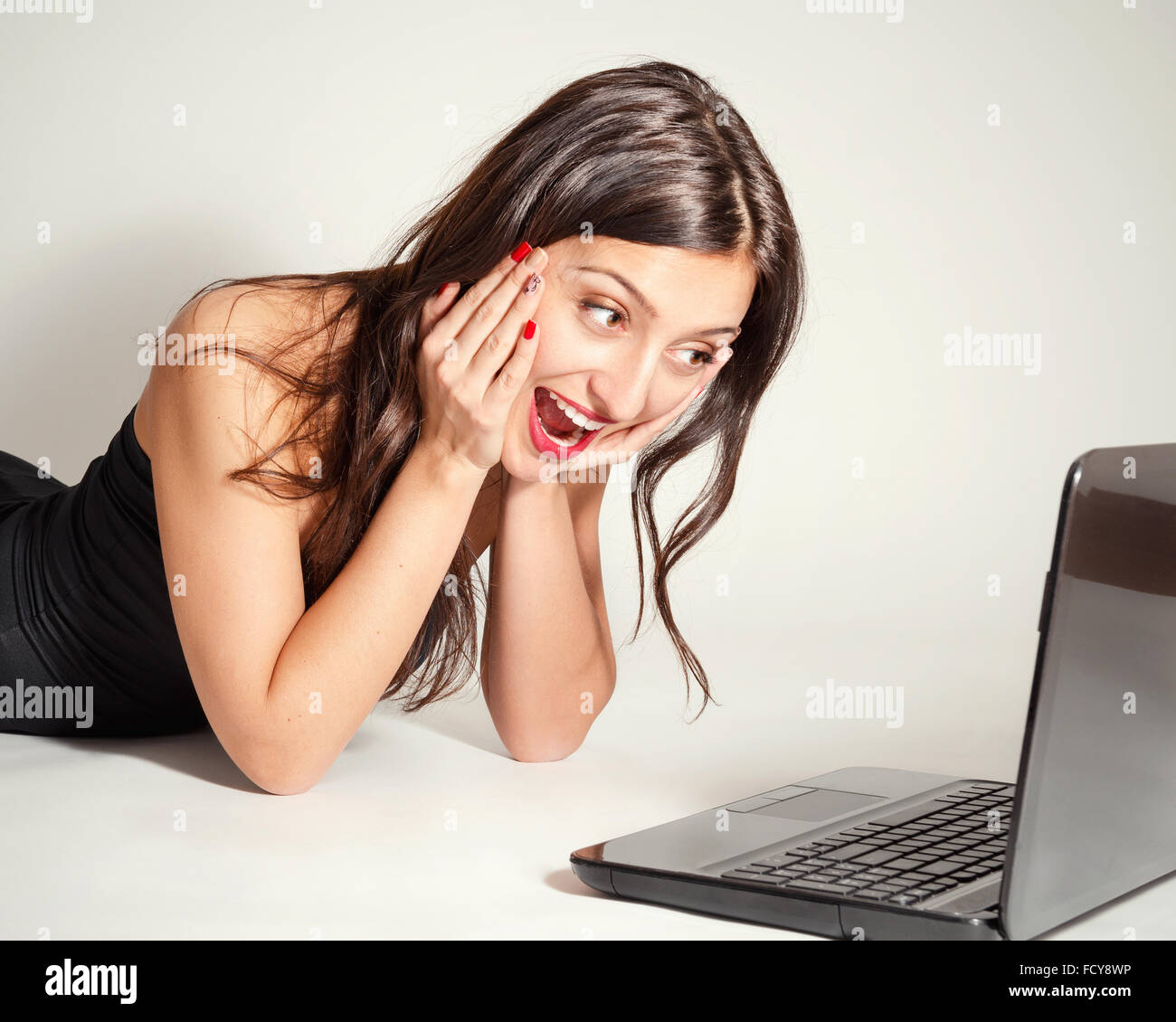 Portrait of beautiful young cheerful woman with a laptop Stock Photo ...