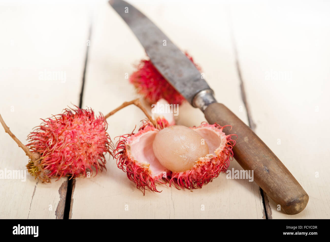 fresh tropical rambutan fruits over rustic wood table Stock Photo - Alamy