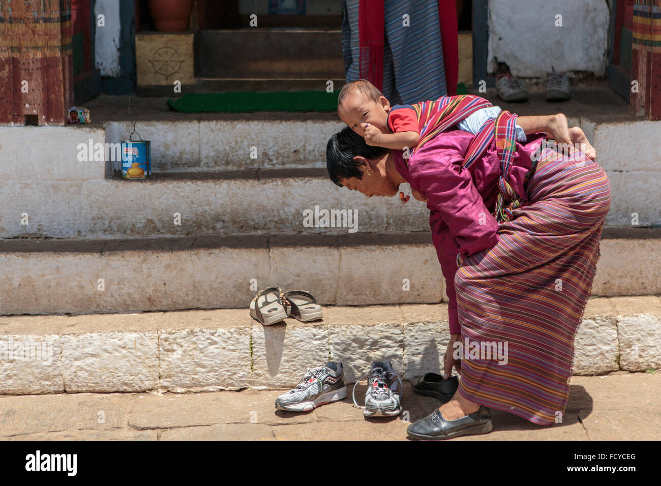 Mother and child at the Temple of the Divine Madman in Punakha, Bhutan Stock Photo