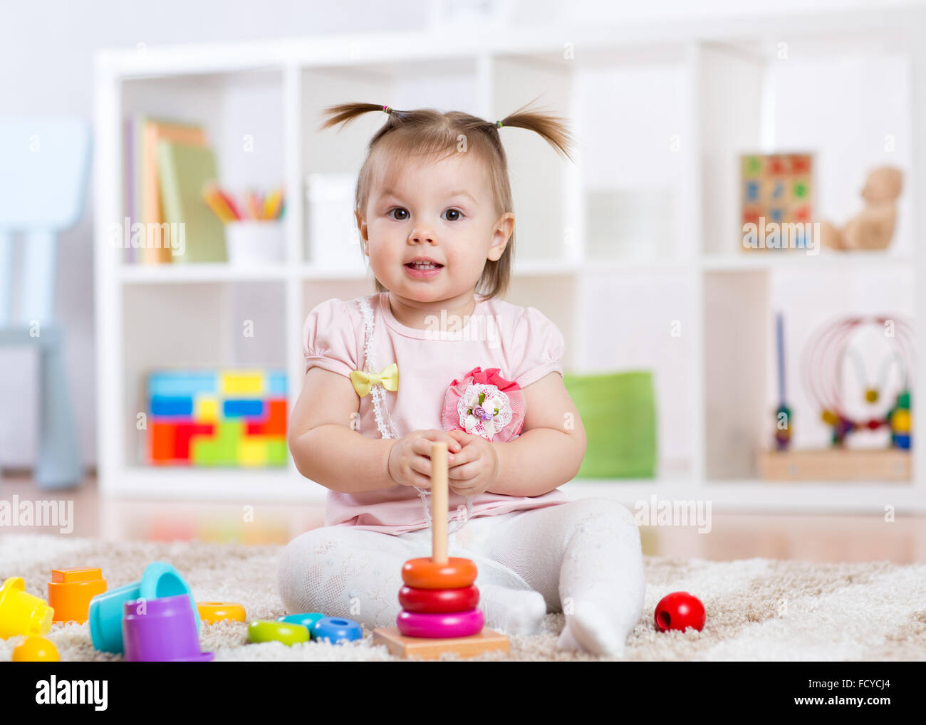 Child girl playing with toy at home Stock Photo - Alamy