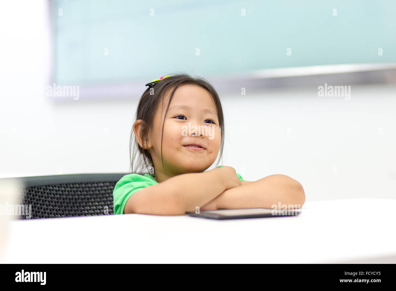 Curious student studying using digital tablet at classroom Stock Photo