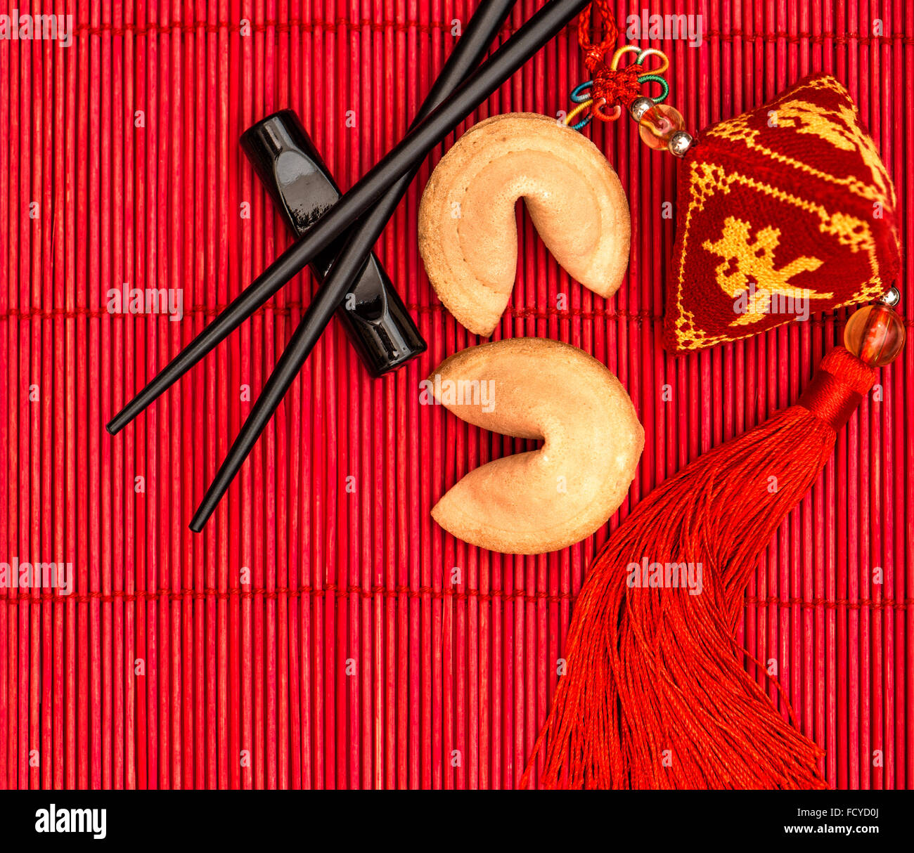 Chinese new years lucky charm, fortune cookies and chopsticks Stock Photo