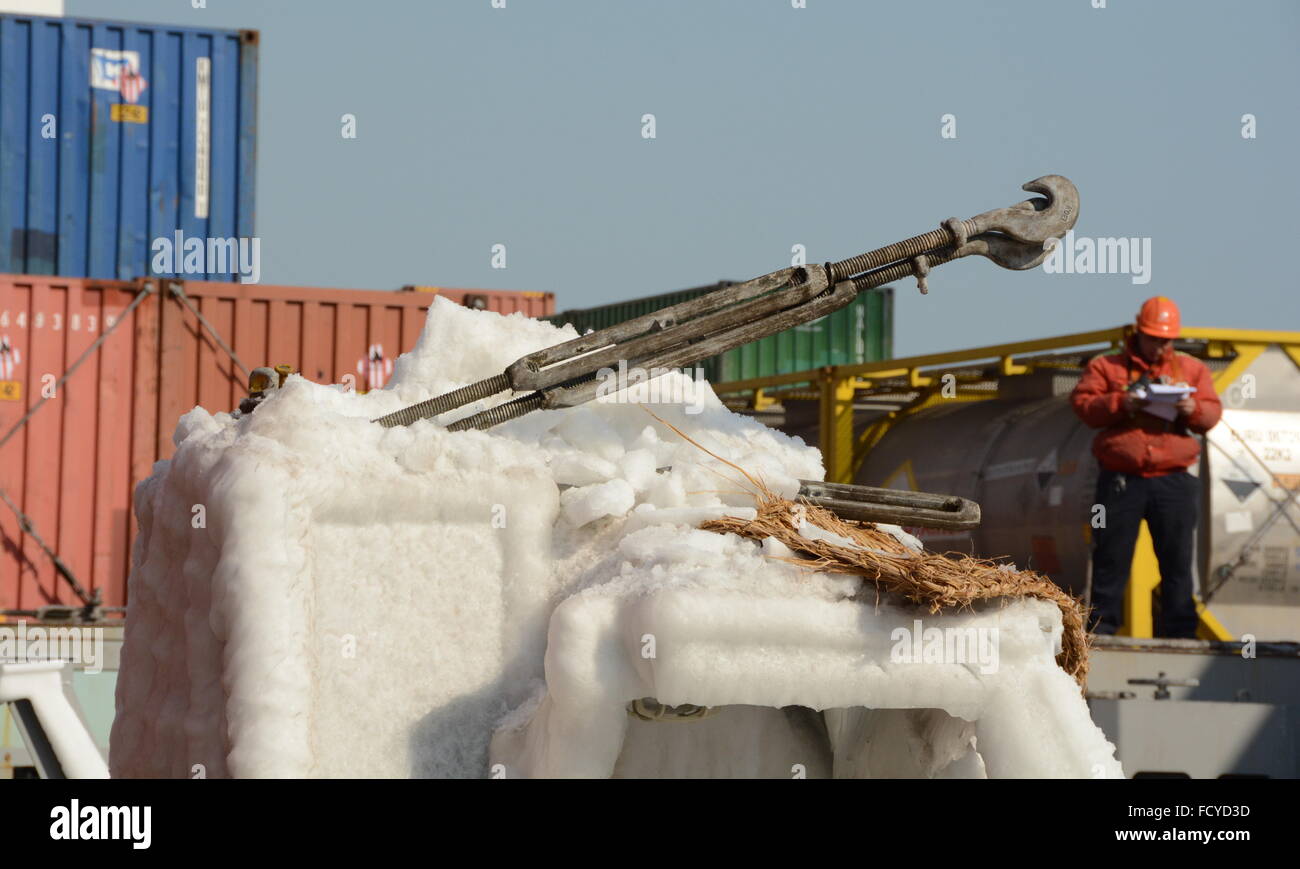 (160126) -- QINGDAO, Jan. 26, 2016 (Xinhua) -- Photo taken on Jan. 26, 2016 shows the ice at a port of Qingdao, east China's Shandong Province. The cargo handling in the port is affected as vessels and containers are covered in ice and snow due to the recent strong cold wave.  (Xinhua/Zhang Xudong) (wyl) Stock Photo