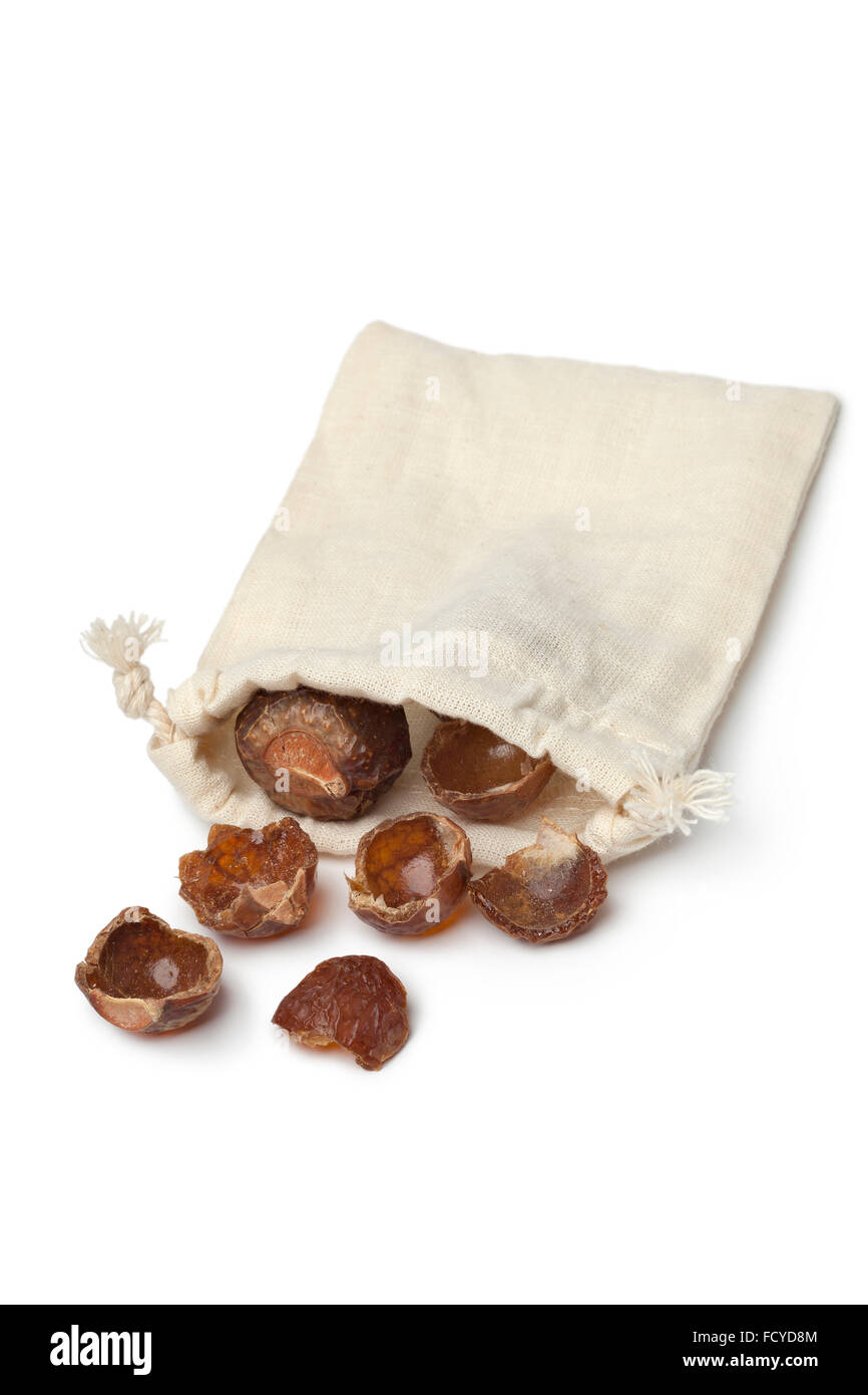 Nutshells of soapnuts in a cotton bag on white background Stock Photo